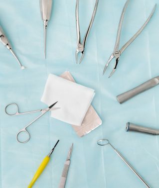 Set of dental tools on blue surface